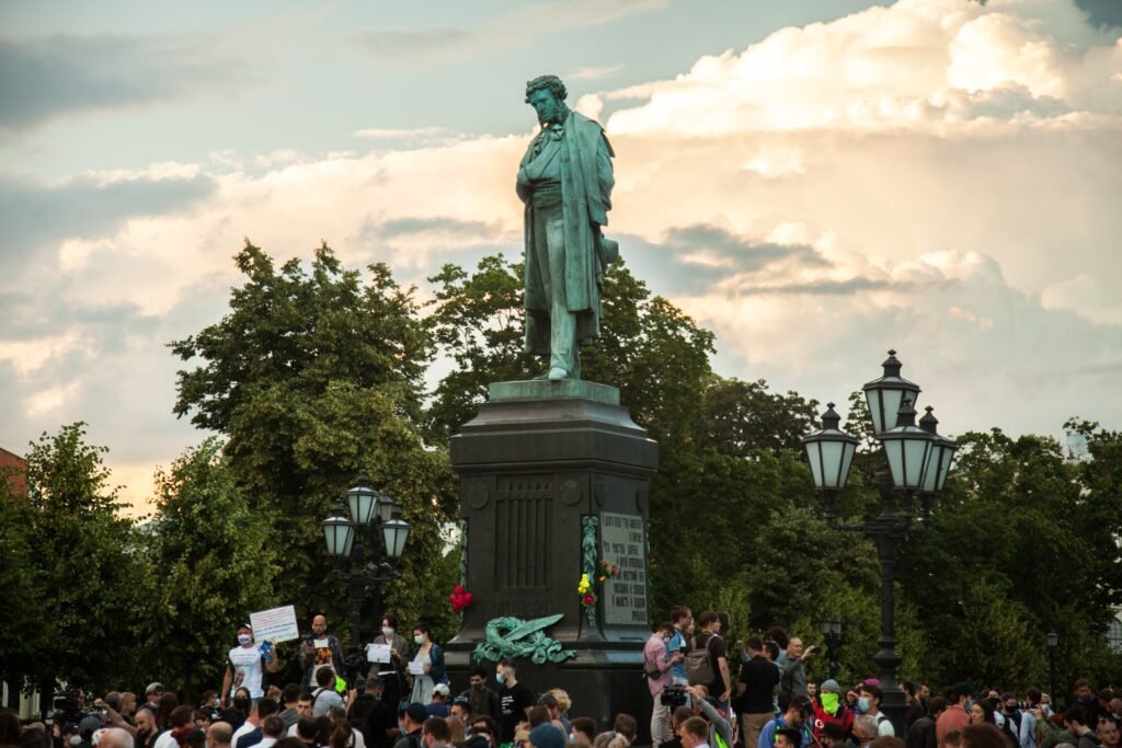 Crowd gathered around a statue in a city square