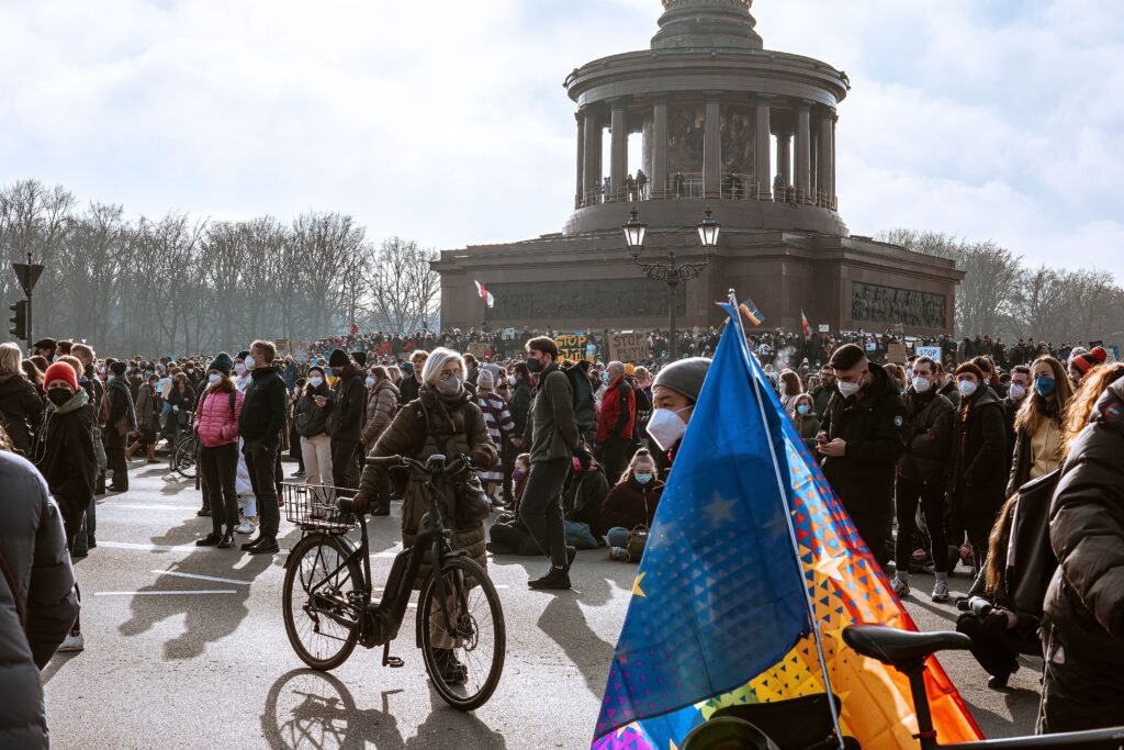 Crowd at a street demonstration in front of a monument