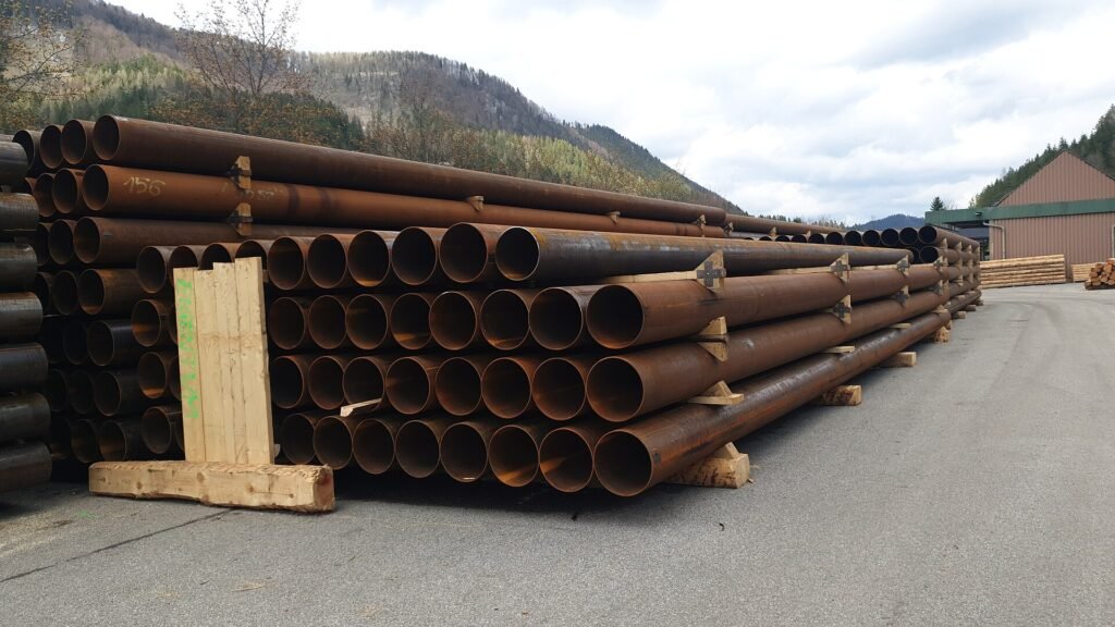Stacked steel pipes in an outdoor storage yard